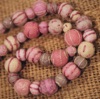 Necklace made from embroidered wool felt beads in shades of soft pink and beige