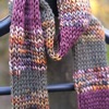 Merino wool skinny scarf in stripes of autumnal marl, green, and purple