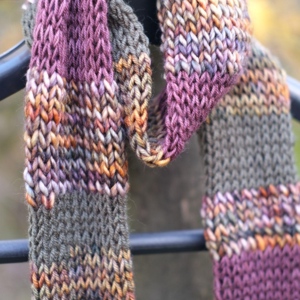 Merino scarf Closeup of a knitted scarf in dark greens, purples, and general autumnal colours